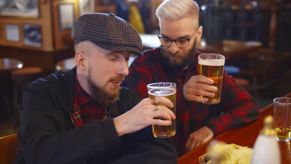 Meeting of Two Male Friends in Bar Discussing Latest News and Smiling