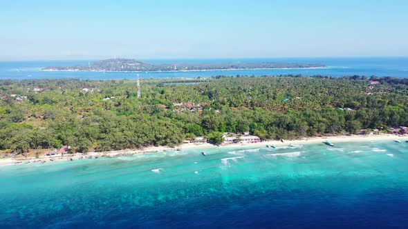 Aerial drone shot scenery of tranquil shore beach adventure by blue lagoon and white sand background