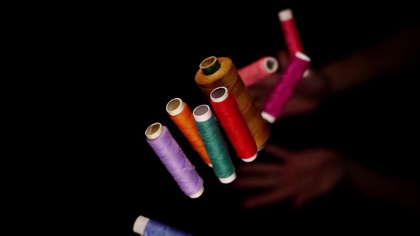 Person Hands Throw Upward Colourful Thread Spools Macro alt