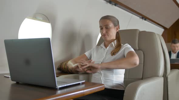 Businesswoman Using Laptop Computer on Business Private Jet Board