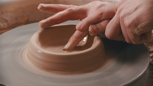 Pottery - the Master Is Unfolding Clay with His Finger on the Potter's Wheel