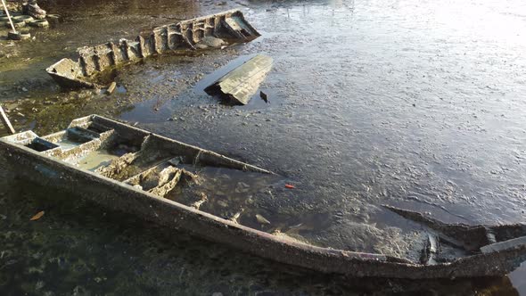 Rusty broken wooden boats sink at coastal