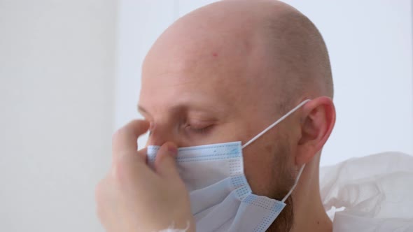 Closeup of the Face of a Doctor Who Puts on a Mask and Goggles Before Working in the Infectious