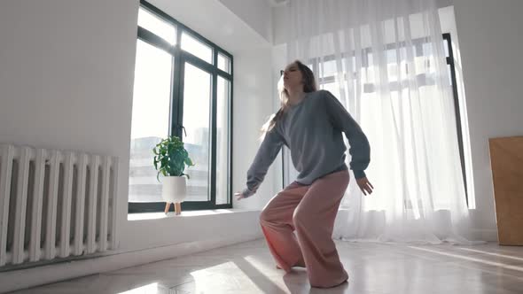 Modern Dancing  a Young Woman Dancing in the Spacious Empty Apartment