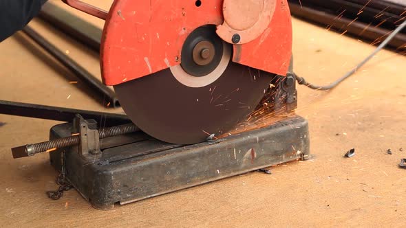 Worker cutting metal and spark with cutting machine