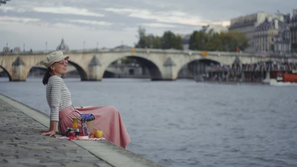 Young girl on a picnic by the Seine