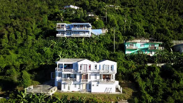 Aerial crane shot of local homes on a hillside on BVI island Tortola.