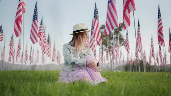 Slow Motion Patriotic Woman Enjoying Sunset View in Park with American Flags
