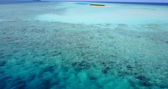 Luxury above abstract shot of a white sandy paradise beach and blue water background in colourful 4K