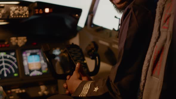 Portrait of Male Captain Sitting in Airplane Cockpit to Start Engine