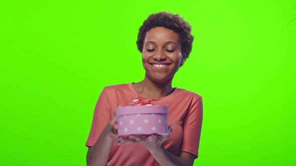 Portrait Cheerful African American Young Woman Joyfully Dancing with Gift Box