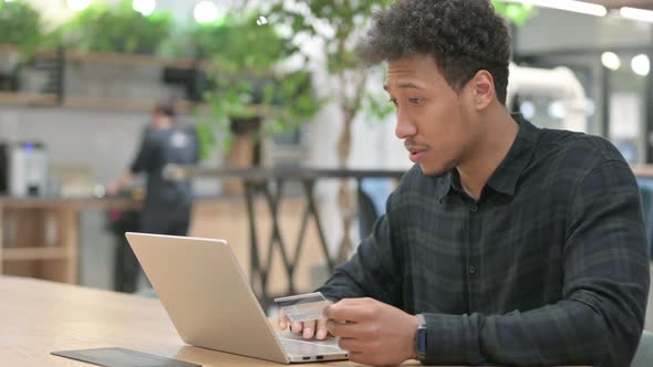 Successful Online Payment on Laptop By African American Man