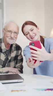 A Young Woman Takes a Selfie with Her Retired Father