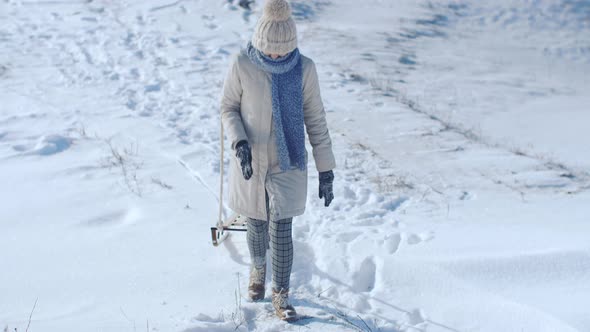 Frozen Funny Woman Dragging Sledge Outdoor