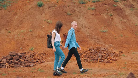 Mars. Hiker Couple in love. Tourists. Travelers with shoulder bags.