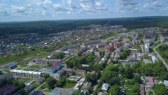 View from a helicopter on a small green summer town