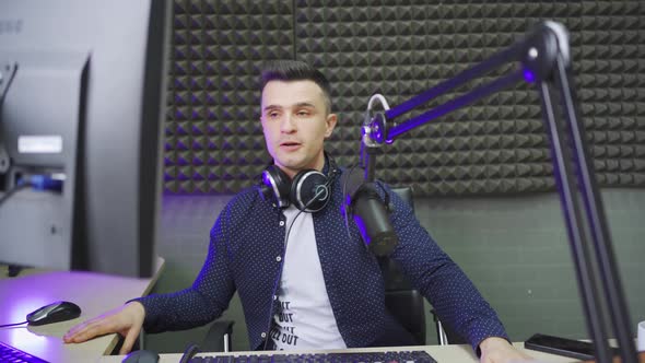 a Radio Host Conducts a Live Broadcast in a Professional Radio Studio