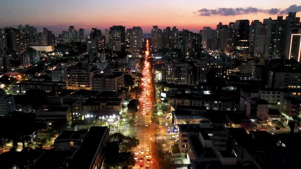 Colorful sunset skyline at landmark avenue of downtown Curitiba, state of Parana, Brazil.