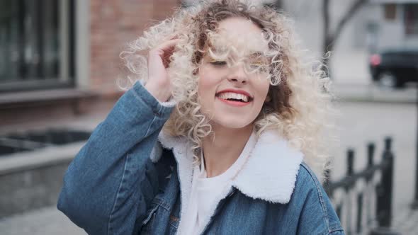 Close-up Portrait of a Cheerful Beautiful and Carefree Girl Walking Around the City.