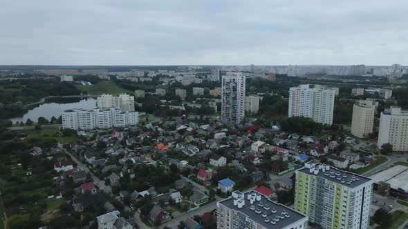 City block. Modern multi-storey buildings. Flying at dusk at sunset.