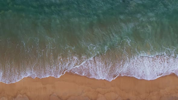 Aerial view Drone camera top down of sea waves in ocean. Turquoise sea surface Amazing sea waves