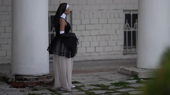 Extravagant Catholic Nun is Walking Near Monastery Sexy Sinful Woman in Religious Gown