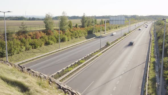 Cars and Trucks Drive on a Busy Highway in a Rural Area  Time Lapse  Top View