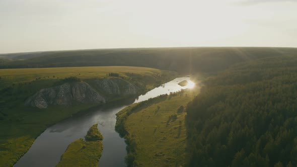 Aerial View of the River with Smooth Water and Forest on the Banks