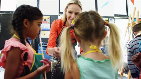 Teacher interacting with students in drawing class