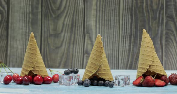 Berry and Fruit Ice Cream. Blueberry, Strawberry, Cherry in a Waffle Cone