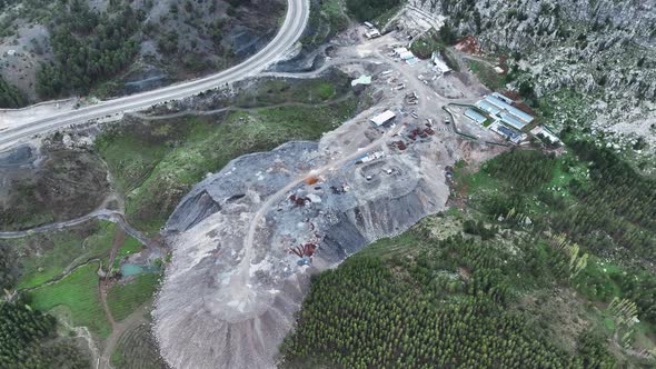 Heavy machinery drills tunnel through the mountain aerial view 4 K