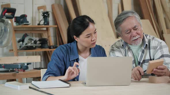 Senior man and woman working with wood