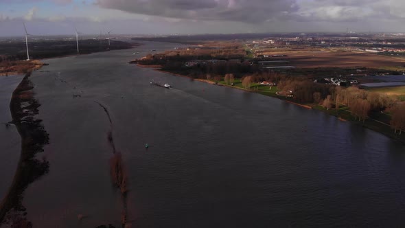 Aerial Over Oude Maas With Ship And Wind Tubrines In Background At Barendrecht. Dolly Forward