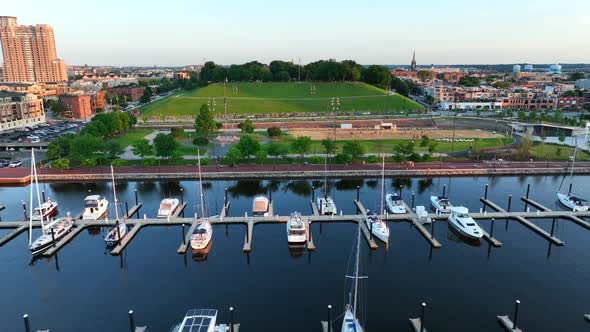 Federal Hill in Baltimore Maryland. Sand volleyball court at sunset. Aerial dolly shot over boat doc