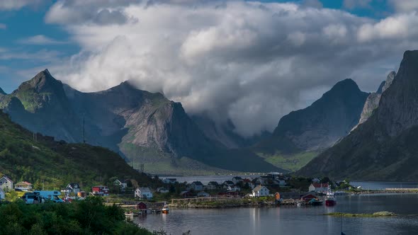 The Movement of Clouds Over Mountain Peaks and a Small Fishing Village in Norway