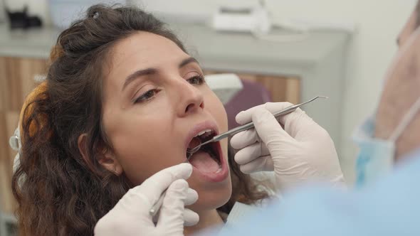 Dentist Examining Female Patient