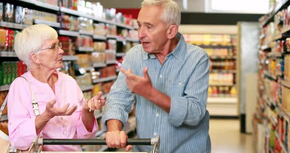 Senior couple arguing in the supermarket