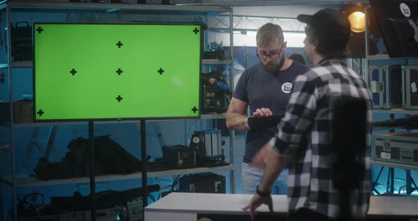 Costumer Checking Video Equipment in Rental Store