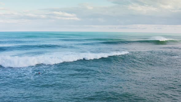 Strong Waves of the Ocean Crashing on the Blue Water Windy Day