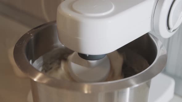 Mechanical Device Automatically Kneads Cake Dough in the Kitchen
