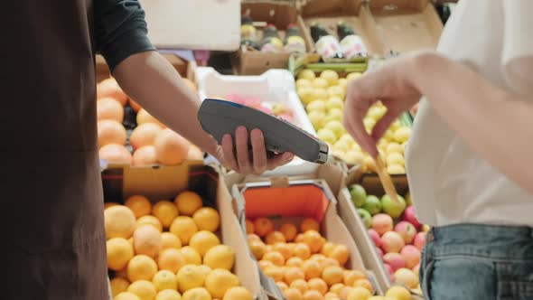 Unrecognizable Woman Making Payment at Market