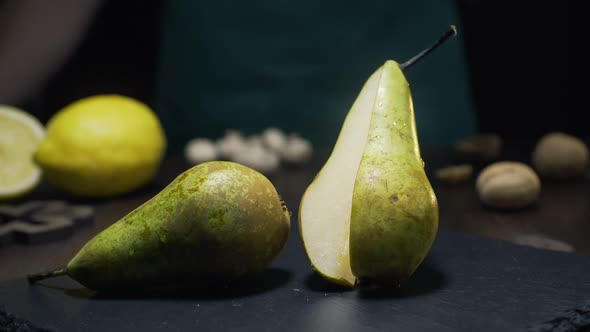 Slide Zooming Shot: Chef Takes Piece of Raw Juicy Pear, Fresh Fruit, Ingredients for Fruit Salad