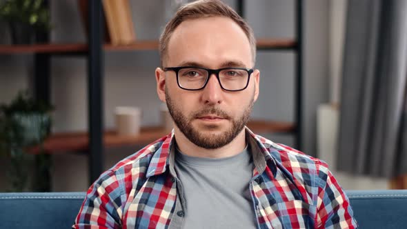 Successful Business Man in Casual Trendy Checkered Shirt and Glasses Posing at Domestic Interior