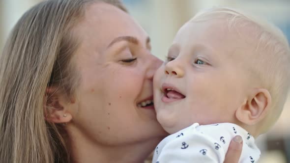 Mother Kissing Sweet Toddler