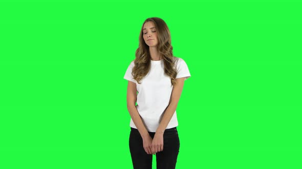 Lovable Girl Disappointed Looking in Camera Then Shrugs. Green Screen