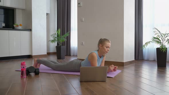 Woman Doing Yoga Plank Watching Tutorial Laptop