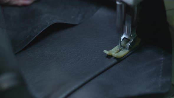 Closeup of Sewing a Needle Seam on a Black Leather Jacket on a Sewing Machine