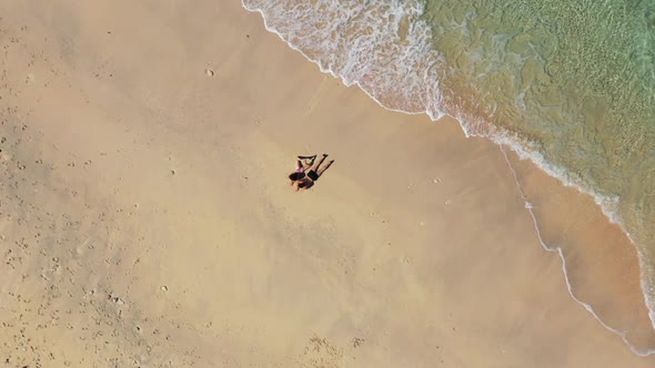 Teenage lovers posing on beautiful seashore beach adventure by blue lagoon and white sandy backgroun