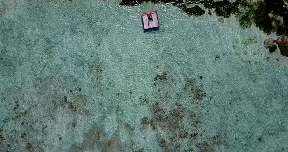 Wide angle drone tourism shot of a summer white paradise sand beach and aqua turquoise water background