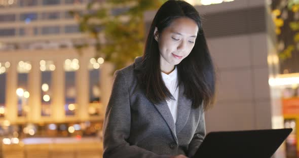 Business Woman Use of Laptop Computer at Night